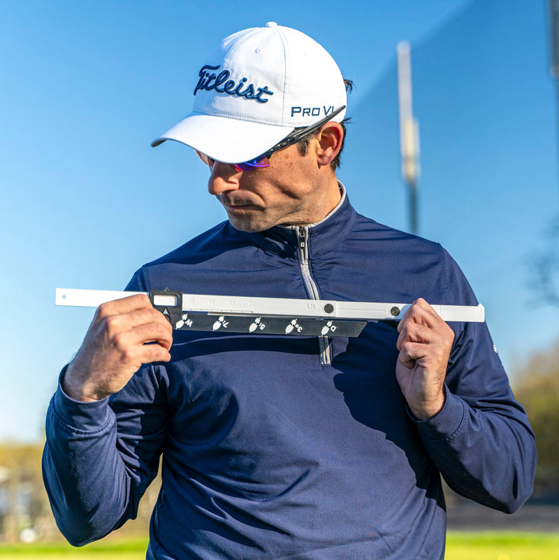 Golfer measuring Stance Caddy against their shoulders 